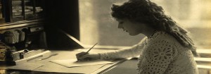 Mary Pickford writing at a desk